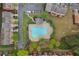 Aerial view of a community pool, parking, manicured landscaping, and surrounding townhomes at 4880 Payson Se Ter, Atlanta, GA 30339