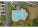 Aerial view of community pool surrounded by trees and landscape. Parking and townhomes are close at 4880 Payson Se Ter, Atlanta, GA 30339