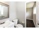 Bathroom featuring a white vanity, mirror, toilet, and an open doorway to another room at 6497 King William Dr, Morrow, GA 30260
