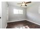 Bedroom featuring hardwood floors, neutral colored walls, a ceiling fan, and window at 6497 King William Dr, Morrow, GA 30260