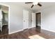 Bedroom showcasing hardwood floors, three doors, two windows, and neutral colored walls at 6497 King William Dr, Morrow, GA 30260
