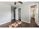 Bedroom with hardwood floors, closet, and two doors to other rooms at 6497 King William Dr, Morrow, GA 30260