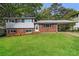 Charming brick home with a well-maintained lawn and carport offers classic curb appeal at 6497 King William Dr, Morrow, GA 30260