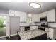 Updated kitchen with white cabinets, granite countertops, stainless steel appliances, and island at 6497 King William Dr, Morrow, GA 30260