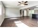 Spacious living room featuring hardwood floors with a view of the stairs and kitchen at 6497 King William Dr, Morrow, GA 30260