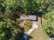 Aerial view of the home showcasing the roof, driveway, and surrounding trees at 125 Valley View Ct, Tyrone, GA 30290