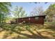 Backyard featuring home, deck, and mature trees at 125 Valley View Ct, Tyrone, GA 30290