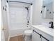 Well-lit bathroom with a shower-tub combo, toilet, vanity with modern fixtures, and wood-look flooring at 125 Valley View Ct, Tyrone, GA 30290