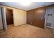 Spacious bedroom with paneled walls and a closet offers a rustic charm, along with access to other rooms at 125 Valley View Ct, Tyrone, GA 30290