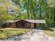 Charming single story brick home with mature trees and a covered carport at 125 Valley View Ct, Tyrone, GA 30290