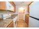 Functional kitchen showcases modern appliances, light wood cabinets, and access to an adjacent laundry area at 125 Valley View Ct, Tyrone, GA 30290