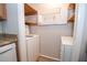 Convenient laundry area with shelving for storage, a washing machine, and light colored flooring at 125 Valley View Ct, Tyrone, GA 30290