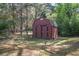 Exterior view of the storage shed with a double door in the backyard at 125 Valley View Ct, Tyrone, GA 30290