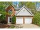 Charming two-story home featuring a brick facade, gray siding, and a two-car garage at 1433 Chardin Dr, Marietta, GA 30062