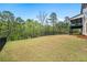 Spacious backyard with lush lawn, trees, and a wrought iron fence offering privacy at 185 Vandiver Ct, Acworth, GA 30101
