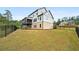 Expansive backyard featuring an iron fence, grass lawn, and covered deck, perfect for outdoor activities at 185 Vandiver Ct, Acworth, GA 30101