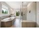 Luxurious bathroom with soaking tub, walk-in glass shower, tile floors, and modern fixtures at 185 Vandiver Ct, Acworth, GA 30101