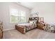 Bright bedroom featuring carpeted floors, large window, bed, and matching furniture at 185 Vandiver Ct, Acworth, GA 30101
