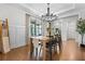 Bright dining area featuring hardwood floors, modern chandelier, and large window with natural light at 185 Vandiver Ct, Acworth, GA 30101