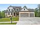 Beautiful two-story home with a brick and shingle facade, three-car garage, and well-manicured lawn at 185 Vandiver Ct, Acworth, GA 30101
