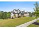 A beautiful two-story home with brick and siding, complemented by a landscaped front yard and concrete sidewalk at 185 Vandiver Ct, Acworth, GA 30101
