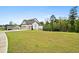 An exterior view of a home with a spacious lawn, three-car garage, and side entry for added convenience at 185 Vandiver Ct, Acworth, GA 30101
