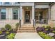 Charming front porch with brick stairs, wrought iron railing, and colorful landscaping at 185 Vandiver Ct, Acworth, GA 30101