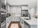 Modern kitchen features stainless appliances, white cabinets, hardwood floors, and ample counter space at 185 Vandiver Ct, Acworth, GA 30101