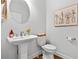 Charming powder room with pedestal sink, floral artwork, and neutral paint at 185 Vandiver Ct, Acworth, GA 30101