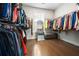 Spacious walk-in closet with dark wood floors and an abundance of hanging storage at 185 Vandiver Ct, Acworth, GA 30101