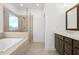 Modern bathroom features tile flooring and glass shower with garden tub beneath a picture window with an exterior view at 2842 Evanshire Ave # 113, Duluth, GA 30096