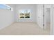 A bright and neutral bedroom with picture windows overlooking the property at 2842 Evanshire Ave # 113, Duluth, GA 30096