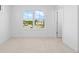 A naturally-lit bedroom with a bright window overlooking the outdoors and neutral walls and flooring at 2842 Evanshire Ave # 113, Duluth, GA 30096