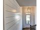 Bright entryway featuring stylish shiplap walls, wood floors, and a modern chandelier over the front door at 2842 Evanshire Ave # 113, Duluth, GA 30096