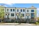 Exterior view of newly constructed townhomes showcasing brick and painted siding with black-trimmed windows at 2842 Evanshire Ave # 113, Duluth, GA 30096