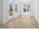 Bright living space with light wood floors, a door to the outside, and a double window at 2842 Evanshire Ave # 113, Duluth, GA 30096