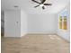 Minimalist living room with a ceiling fan, wood-look floors, and a window with a view at 2842 Evanshire Ave # 113, Duluth, GA 30096