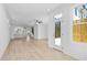 Open living space with light wood floors connecting to the kitchen and an outdoor entrance at 2842 Evanshire Ave # 113, Duluth, GA 30096