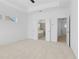 A bright main bedroom features neutral carpeting, tray ceiling, and ensuite bathroom with a glass shower and soaking tub at 2842 Evanshire Ave # 113, Duluth, GA 30096