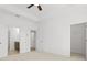 Primary bedroom with tray ceiling, carpeted floor, and access to ensuite bathroom and closet at 2842 Evanshire Ave # 113, Duluth, GA 30096