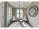 Cozy sitting area with large windows, plush chairs, and decorative clock creating a peaceful atmosphere at 2842 Evanshire Ave # 113, Duluth, GA 30096