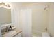 Well-lit bathroom with a shower-tub combo and a granite countertop sink at 4322 Glenwood Pkwy, Decatur, GA 30032