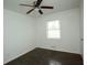 An ample bedroom with hardwood floors, a ceiling fan, a window and white walls at 4322 Glenwood Pkwy, Decatur, GA 30032