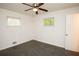 An ample bedroom with hardwood floors, a ceiling fan, two windows and white walls at 4322 Glenwood Pkwy, Decatur, GA 30032