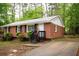 This charming brick home features a concrete driveway and manicured landscaping at 4322 Glenwood Pkwy, Decatur, GA 30032