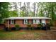 Charming brick home featuring a metal roof and freshly painted trim at 4322 Glenwood Pkwy, Decatur, GA 30032