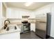 Well-lit kitchen with white cabinets, granite counters, stainless steel appliances, and a modern sink at 4322 Glenwood Pkwy, Decatur, GA 30032