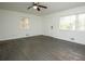 Bright living room featuring a ceiling fan and large windows, newly painted and ready at 4322 Glenwood Pkwy, Decatur, GA 30032