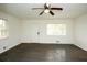 Spacious living room with a ceiling fan, lots of natural light, and neutral wall color at 4322 Glenwood Pkwy, Decatur, GA 30032