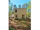Rear exterior of the house with a small patio area and view of the surrounding greenery at 4460 Branchwood Ct, Loganville, GA 30052